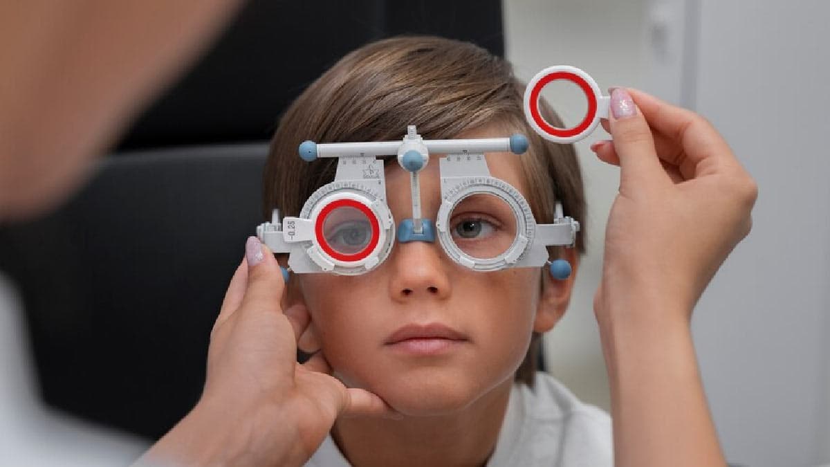 A little boy with visual impairment is being examined and treated.